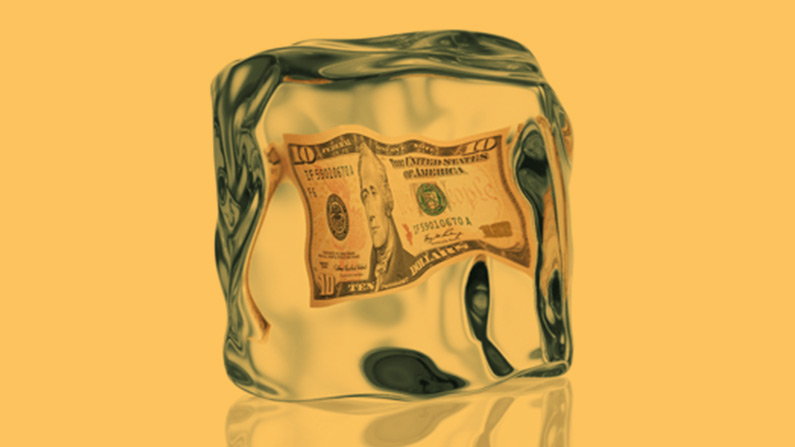 Ten dollar bill inside an ice cube